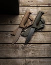 Modern hunting knives with rubberized handles and plastic sheaths. Melee weapons for hunting and self-defense. Vintage wooden back