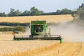 Modern 9780i cts john deere combine harvester cutting crops corn wheat barley working golden field