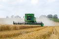 Modern 9780i cts john deere combine harvester cutting crops corn wheat barley working golden field Royalty Free Stock Photo