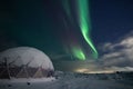 Modern igloo structure illuminated the northern lights. Royalty Free Stock Photo