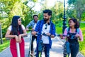 Modern indian friends ride on segway in park in India