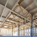 modern industrial hall with timber trusses and prefabricated concrete columns Royalty Free Stock Photo