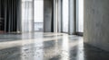 Modern industrial interior featuring polished concrete floors and large windows allowing natural light to create sharp shadows in Royalty Free Stock Photo