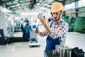 Modern industrial machine operator working in factory