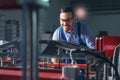 Modern industrial machine operator working in factory. Worker on the machine Royalty Free Stock Photo