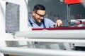 Modern industrial machine operator working in factory. Worker on the machine Royalty Free Stock Photo