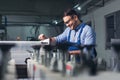 Modern industrial machine operator working in factory. Worker on the machine Royalty Free Stock Photo