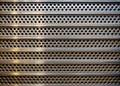 Modern Industrial Ventilation Grid with Textured Metallic Slats and Circular Perforations for Enhanced Airflow and Royalty Free Stock Photo