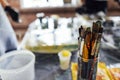 Modern interior of the art workshop or studio. Buckets with paint, dirty glass jars