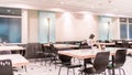 Modern interior of cafeteria or canteen with chairs and tables