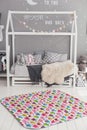 Modern interior of the child`s bedroom with carpet in front Royalty Free Stock Photo