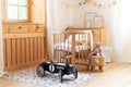 Modern interior of a children`s bedroom. Copy space. Hygge. Kindergarten. Cozy Scandinavian lights baby room: wooden crib with bed Royalty Free Stock Photo