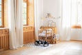 Modern interior of a children`s bedroom. Copy space. Hygge. Kindergarten. Cozy Scandinavian lights baby room: wooden crib with bed Royalty Free Stock Photo