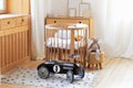 Modern interior of a children`s bedroom. Copy space. Hygge. Kindergarten. Cozy Scandinavian lights baby room: wooden crib with bed Royalty Free Stock Photo