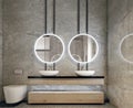 Modern interior design of bathroom vanity, all walls made of stone slabs with circle mirrors, minimalistic and clean concept