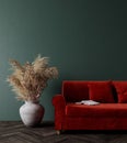 Modern interior design with red couch, dry plants decoration and empty olive green mock up wall