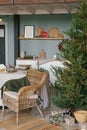 Modern interior design of a room with Christmas and New Year decorations, toys, gifts, a Christmas tree, a wicker chair.