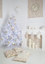 Modern interior of fireplace with christmas tree and presents in white Royalty Free Stock Photo