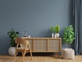 Modern interior of living room with cabinet and chair on dark blue wall background Royalty Free Stock Photo