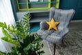 Modern interior in neutral colors. Geometric armchair, work area, potted plant. Children`s room for a boy or teenager. Concept Royalty Free Stock Photo