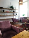 Modern interior. Pink velvet retro armchairs. Stylish composition of cafe interior. Vintage furnitures. Decor of living rooms