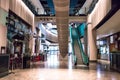 Modern interior of shopping mall food eating restaurant area with escalators Royalty Free Stock Photo