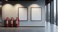Three red fire extinguishers stand beside two blank frames in a modern interior space Royalty Free Stock Photo