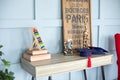 Modern interior study room for child. Desk in a child bedroom. Books, abacus, board, masters hats on wooden table. Concept for Tea Royalty Free Stock Photo