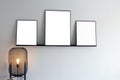 Modern interior and three empty picture frames on the wall, blank poster, canvas space for text in the living room Royalty Free Stock Photo