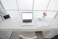 Modern interior workplace with laptop in white colors Royalty Free Stock Photo