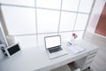 Modern interior workplace with laptop in white colors Royalty Free Stock Photo