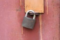 A modern iron padlock hangs on steel the door. Locked door to the premise. Concept of protection, incarceration