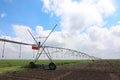 Modern irrigation system in field under sky. Agricultural equipment