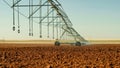 Modern irrigation system sprays water for the new crop at large Texas farm. Center pivot sprinkler mechanism.