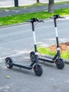 Modern ÃÂity transport - Two electric scooters is parked on the street of the city