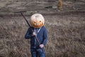 Modern Jack-lantern with a pumpkin on his head standing in the field. Royalty Free Stock Photo