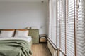 Modern Japandi bedroom interior design in moss green tones, natural textures with wooden shades Royalty Free Stock Photo