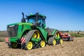 Modern john deere caterpilla tractor cultivating English crop field Royalty Free Stock Photo