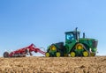 Modern john deere caterpilla tractor cultivating English crop field Royalty Free Stock Photo