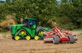 Modern john deere caterpilla tractor cultivating English crop field Royalty Free Stock Photo