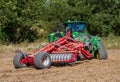 Modern john deere caterpilla tractor cultivating English crop field Royalty Free Stock Photo