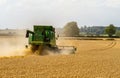 Modern John Deere combine harvester cutting crops Royalty Free Stock Photo