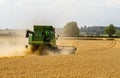 Modern John Deere combine harvester cutting crops