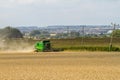 Modern John Deere combine harvester cutting crops
