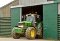 Modern John Deere tractor parked in barn Royalty Free Stock Photo