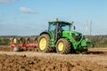 Modern John Deere tractor pulling a plough Royalty Free Stock Photo