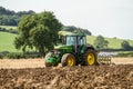 Modern John Deere tractor pulling a plough