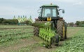 Modern John Deere tractor pulling a plough