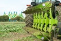 Modern John Deere tractor pulling a plough