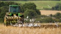 Modern John Deere tractor pulling a plough